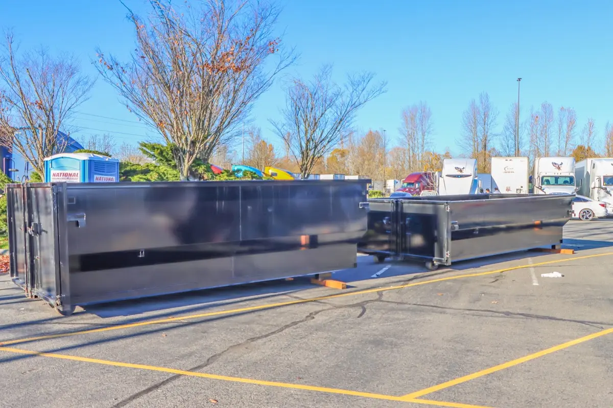 Professional dumpster rental service with roll-off container on residential driveway in Ruskin